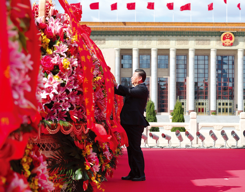 2018年9月30日上午,党和国家领导人习近平、李克强、栗战书、汪洋、王沪宁、赵乐际、韩正、王岐山等来到北京天安门广场,出席烈士纪念日向人民英雄敬献花篮仪式。这是习近平整理花篮上的缎带。 新华社记者 谢环驰/摄